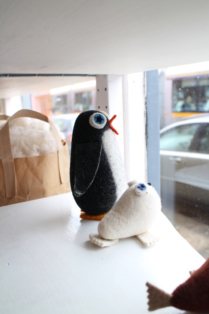 A Penguin and a seal looking wistfully out the window